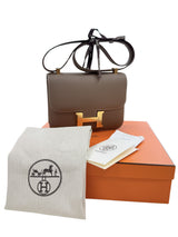 Hermès Constance 24 Brown Epsom Leather Crossbody Shoulder Bag displayed with its box and accessories.