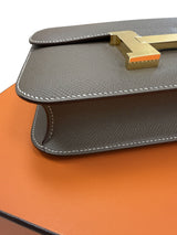 Close-up of the leather flap and gold clasp on the Hermès Constance 24 Brown Epsom Leather Crossbody Shoulder Bag.